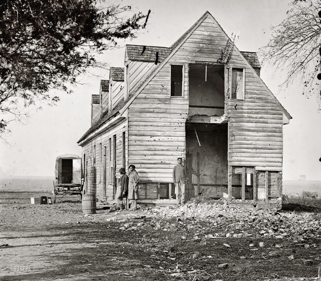 Men at a damaged house