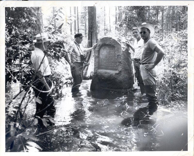 Men at a forest monument