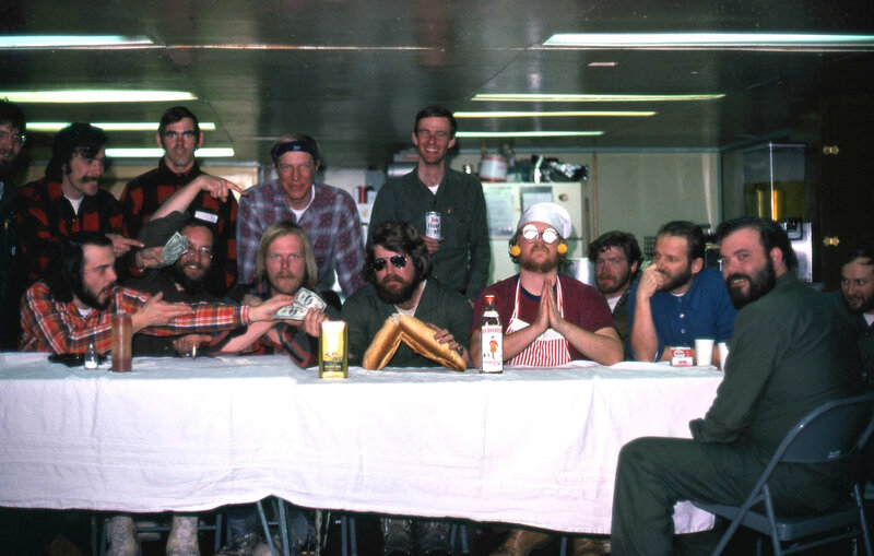 Men at a long table with food