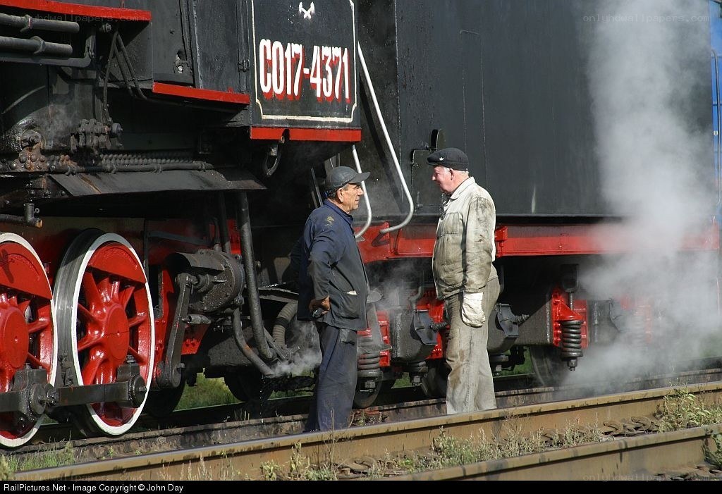 Men by a steam locomotive