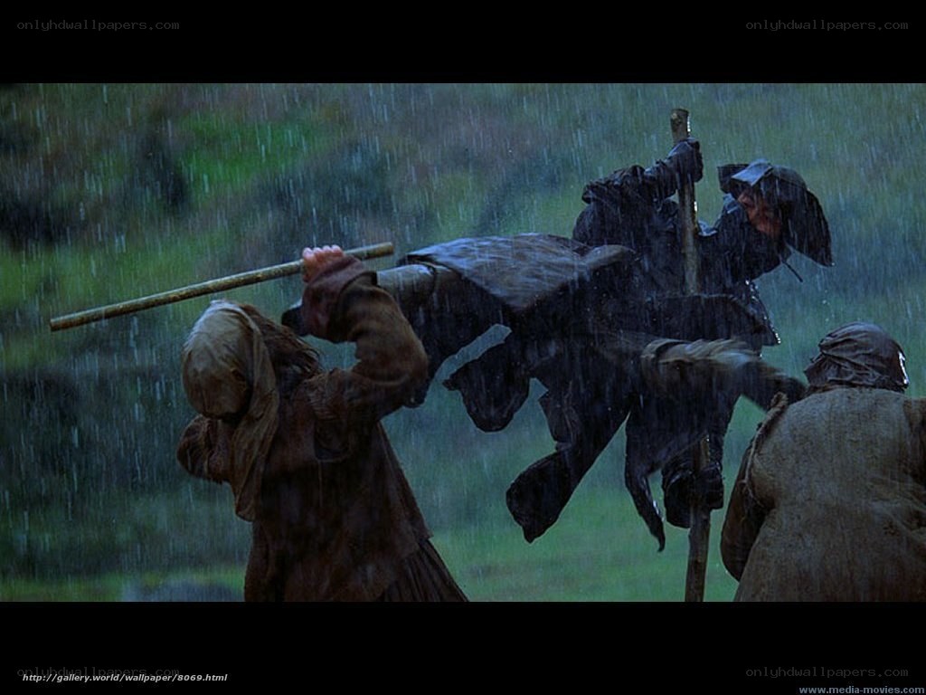 Men carrying a body in rain