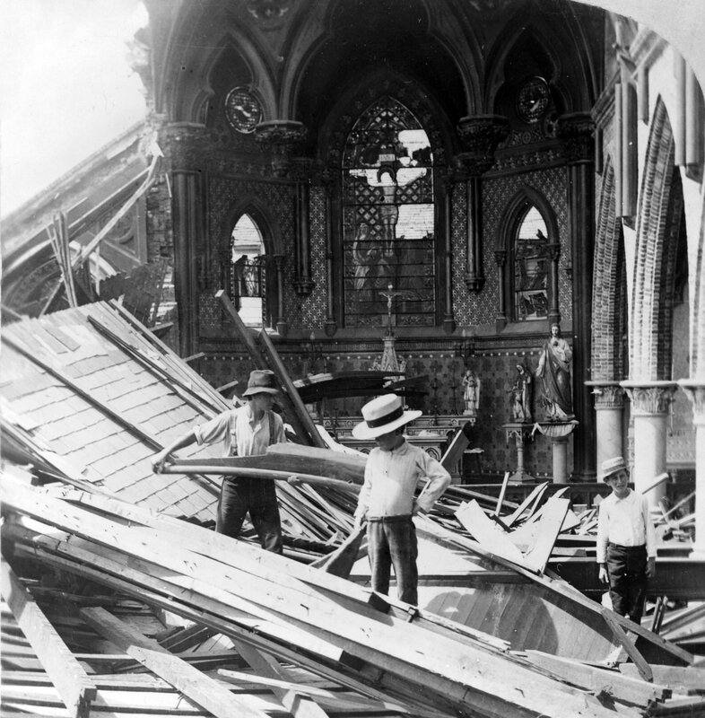 Men clearing debris in a damaged church