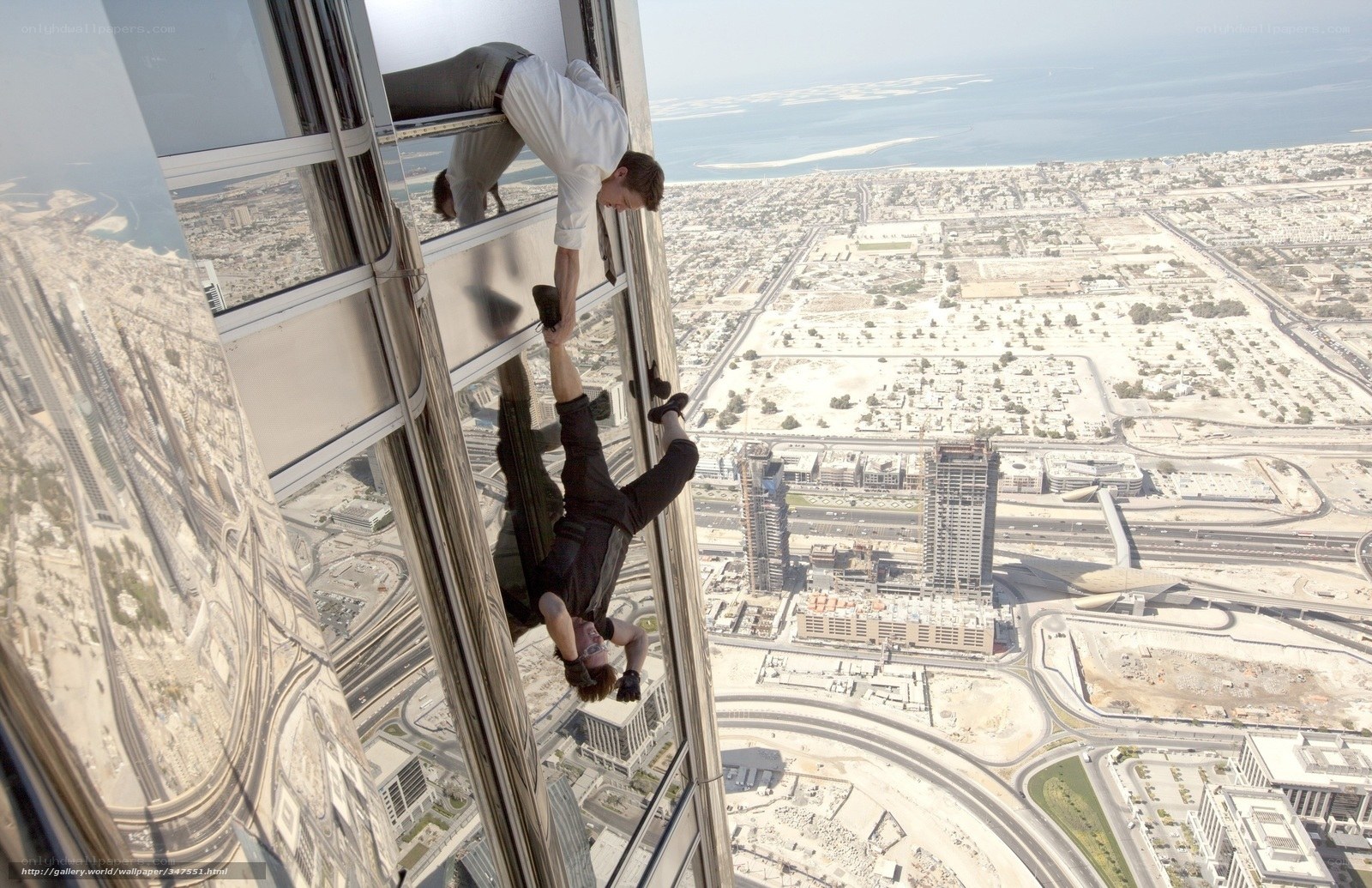 Men climbing skyscraper exterior