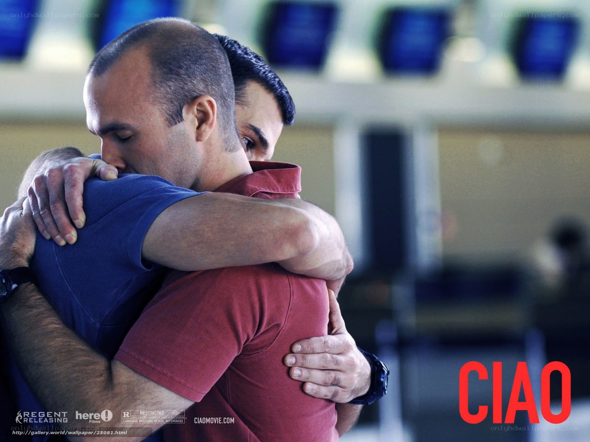 men embracing in airport
