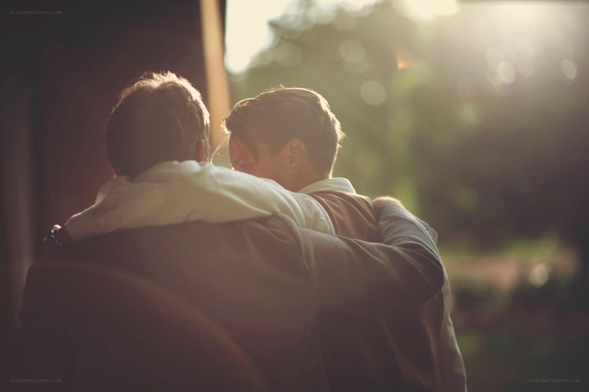 men embracing in sunlight