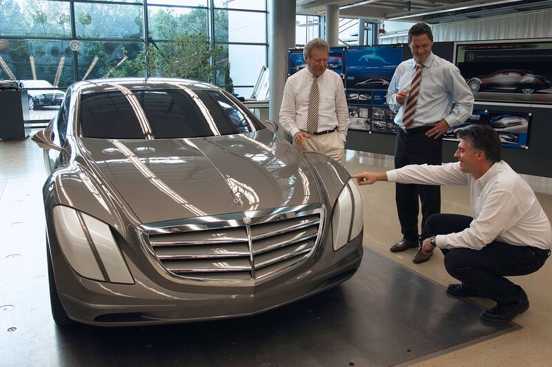 Men examining a concept car