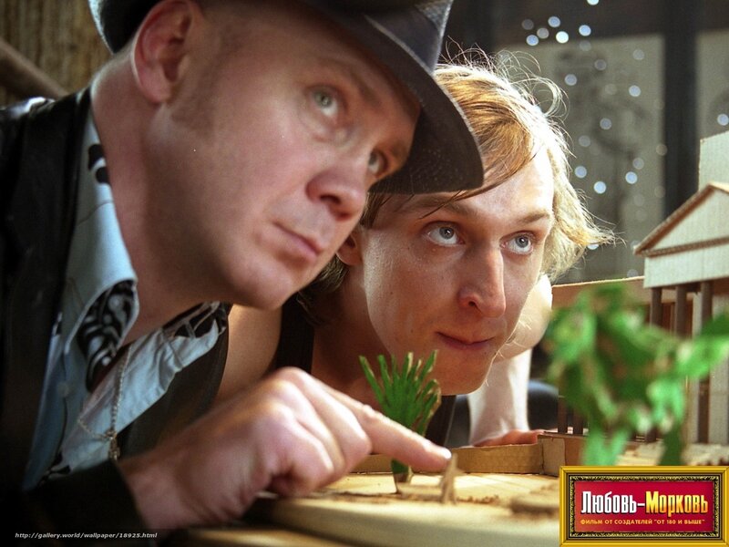 Men examining model architecture