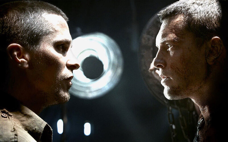 Men facing off in dark room