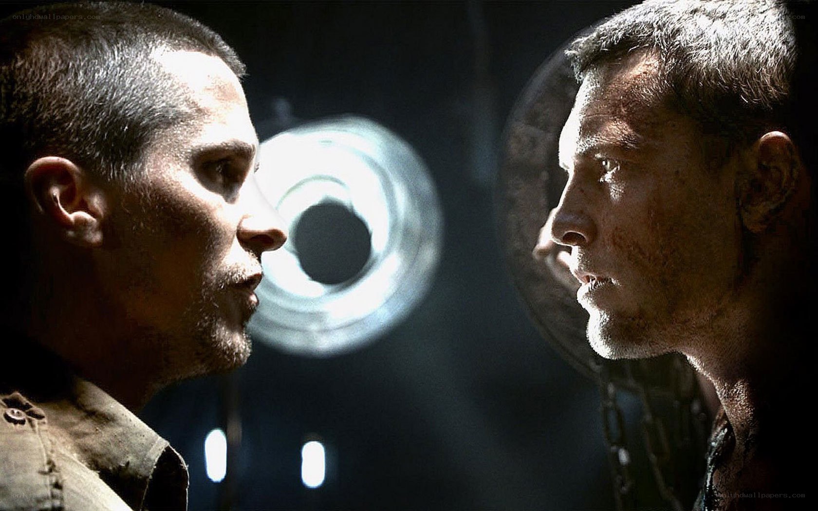 Men facing off in dark room