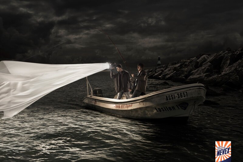 Men fishing with light beam