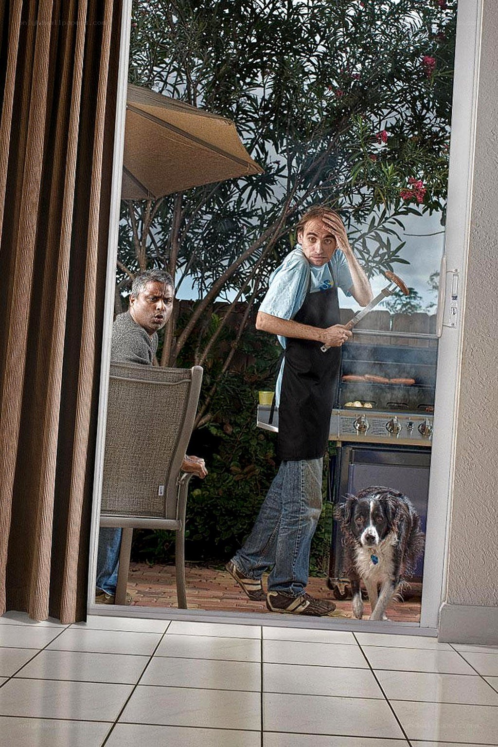 Men grilling with dog outside