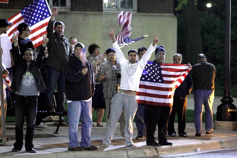 Men Holding American Flags