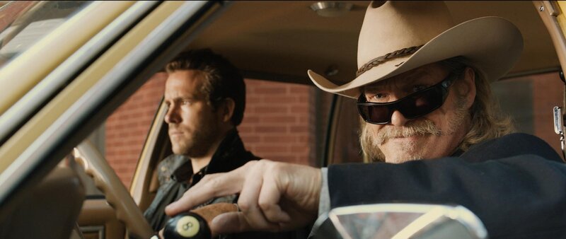 Men in a car with cowboy hat