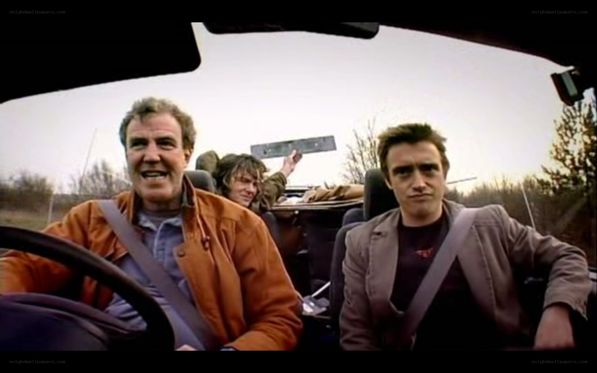Men in a convertible car