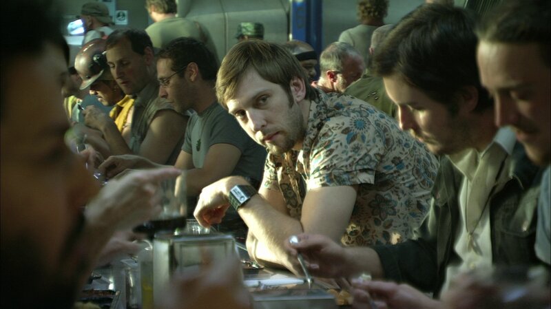 Men in a crowded cafeteria