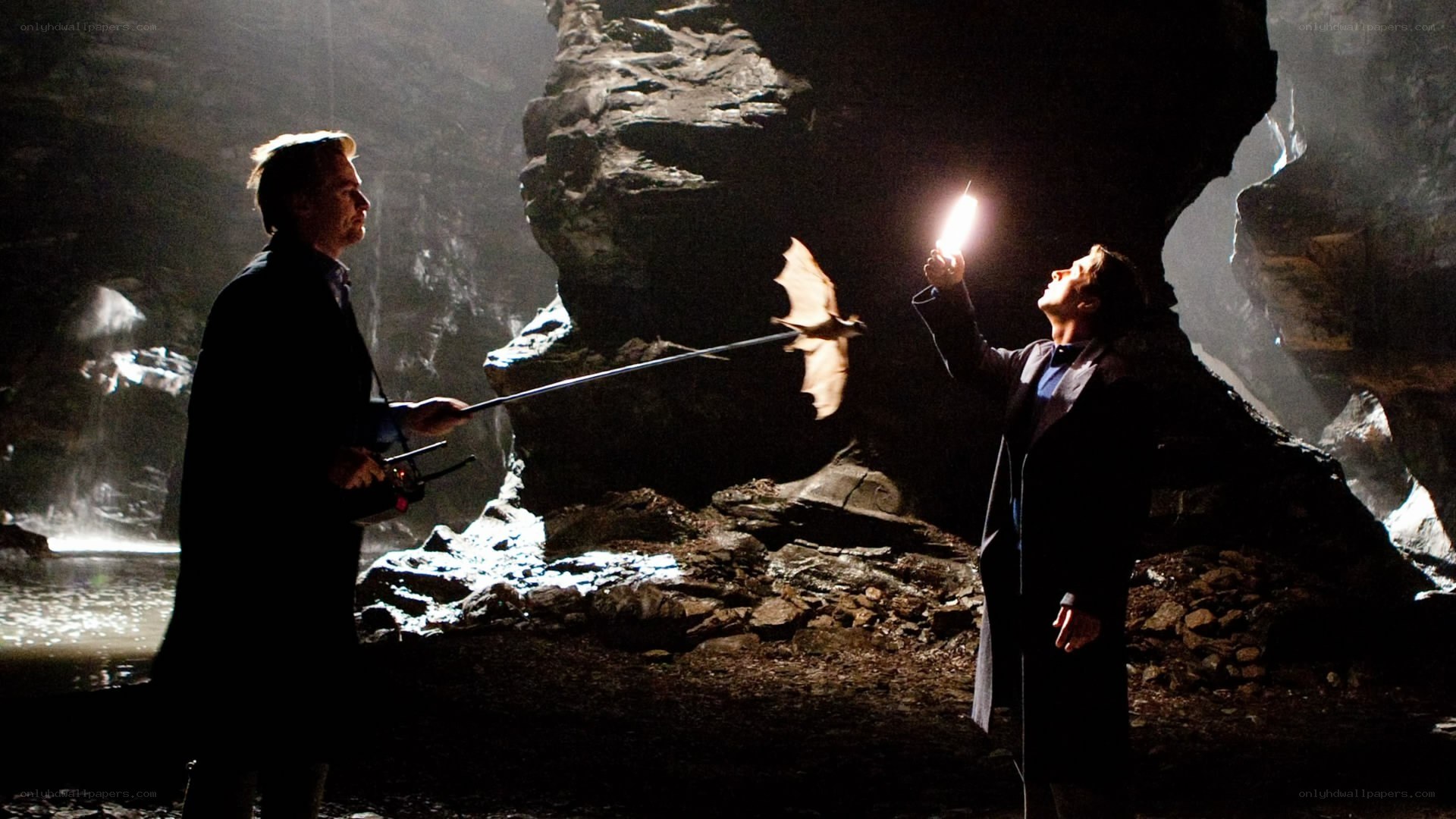 Men in a dark cave with bat