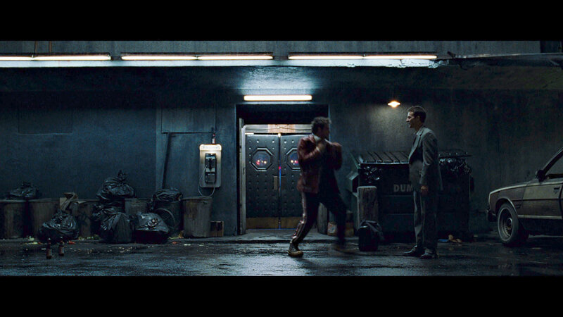 Men in a dimly lit alley
