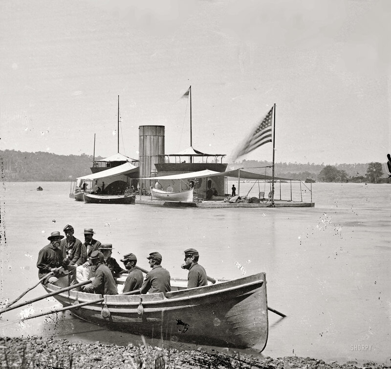 Men in a rowboat near a steamship