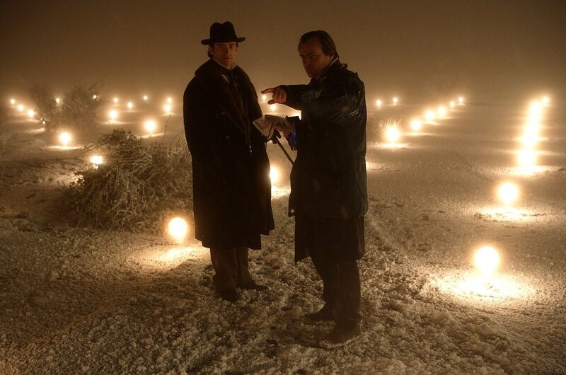 Men in a snowy field at night