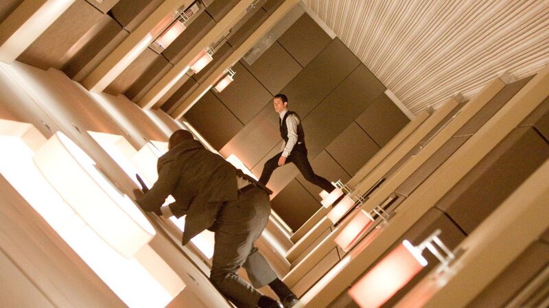 Men in a tilted corridor