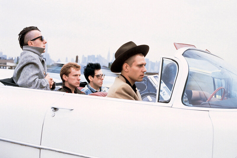 Men in a white convertible car