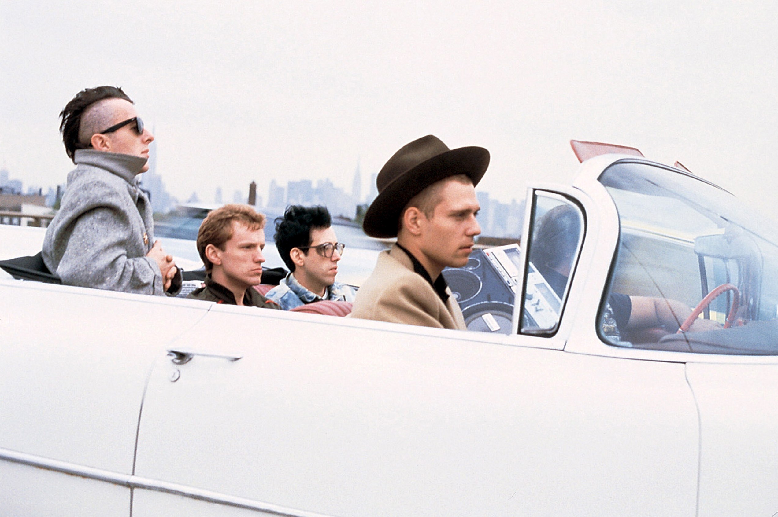 Men in a white convertible car