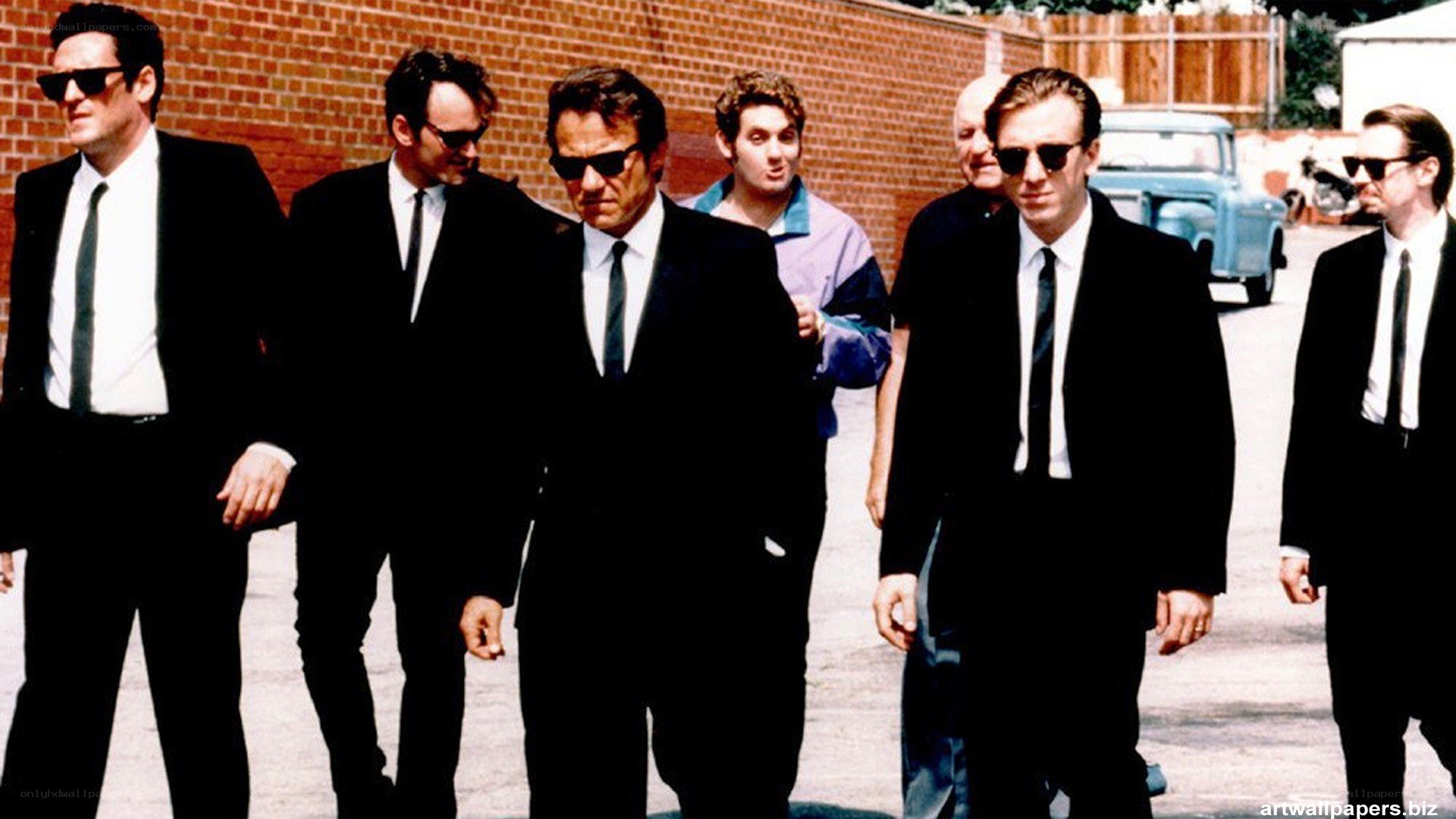 men in black suits walking