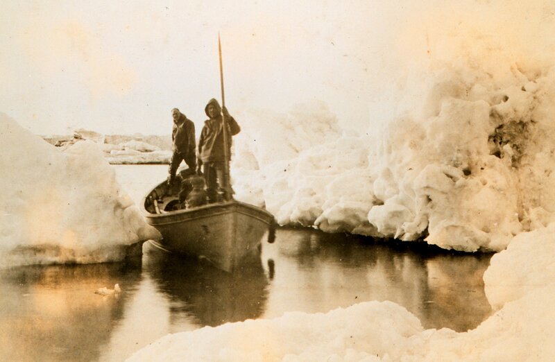 Men in boat on icy water