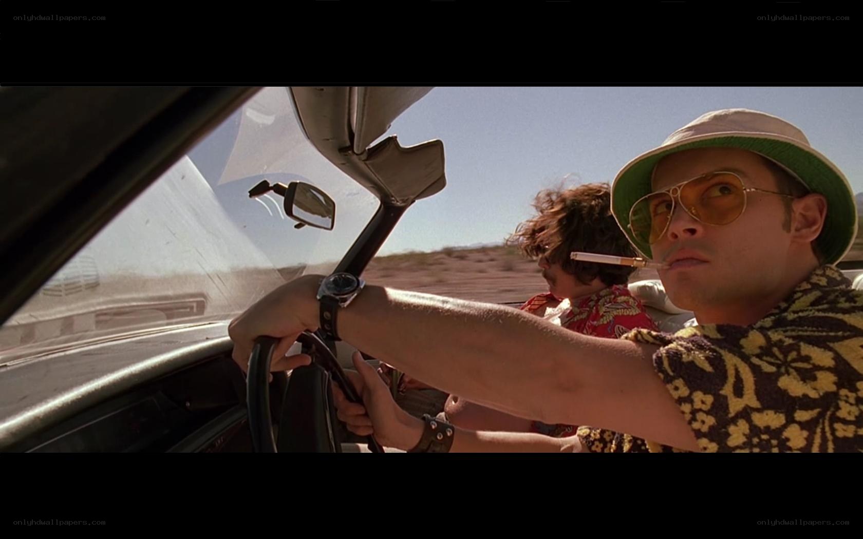 men in car driving desert