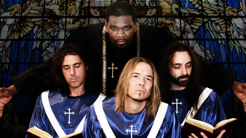 Men in choir robes with stained glass