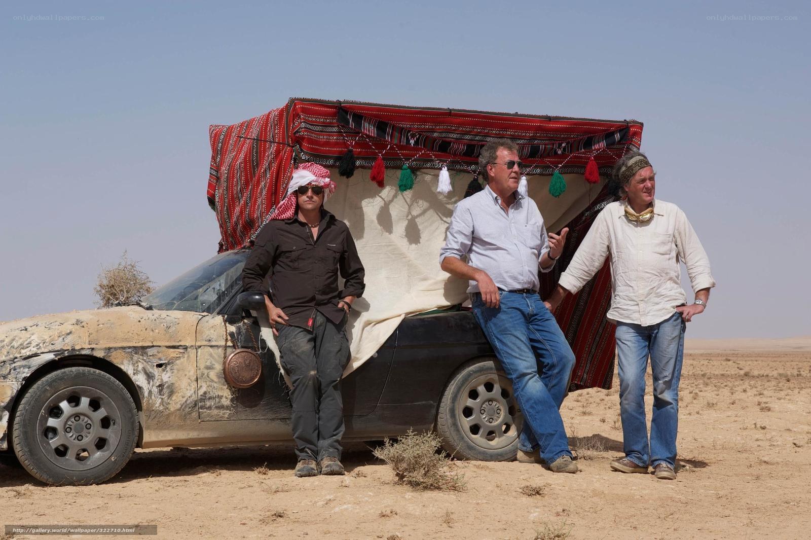 Men in desert with covered car