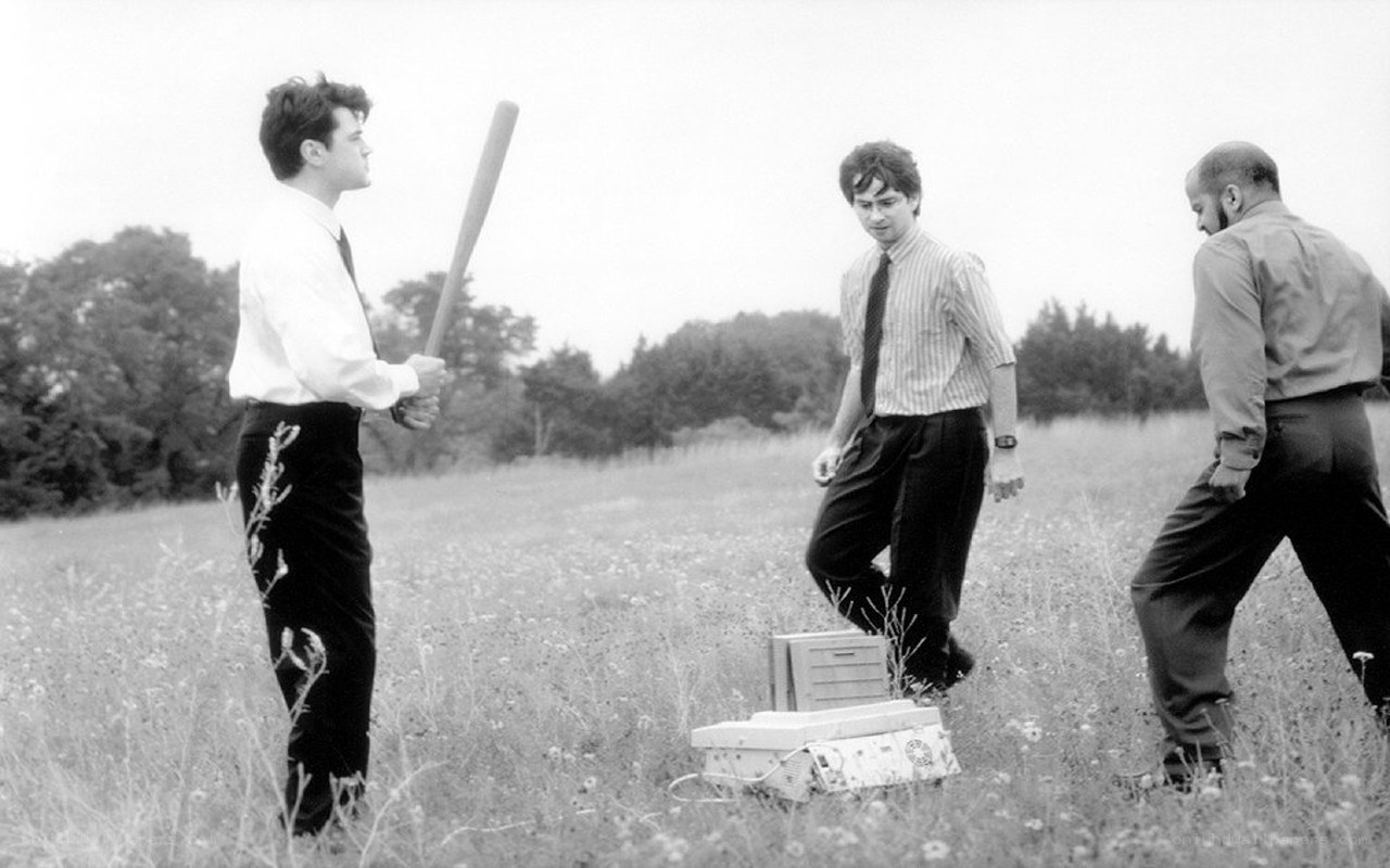 Men in field with baseball bat