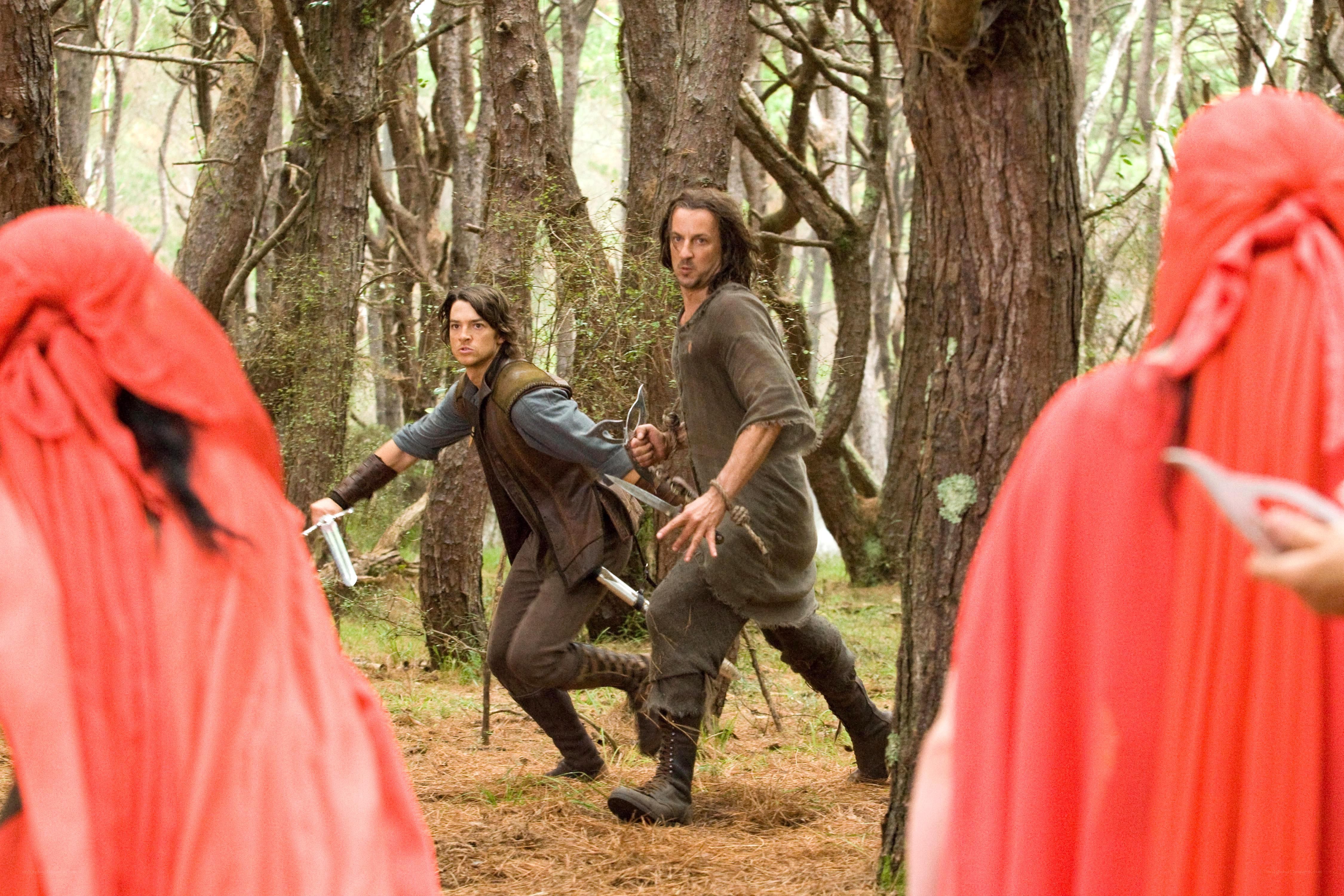 Men in forest with swords