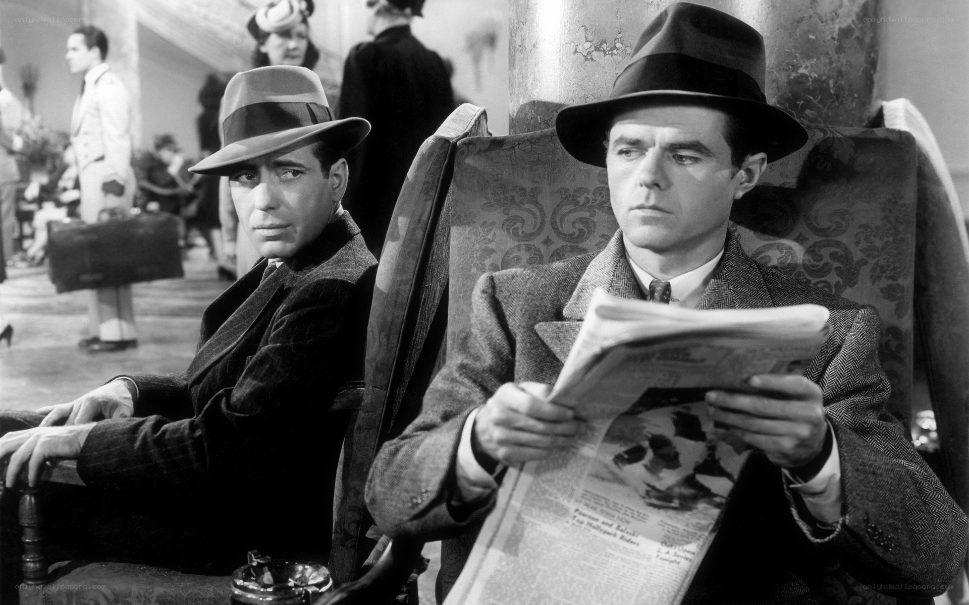 Men in hats reading newspaper