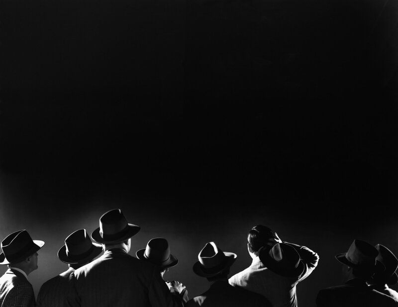 men in hats watching performance