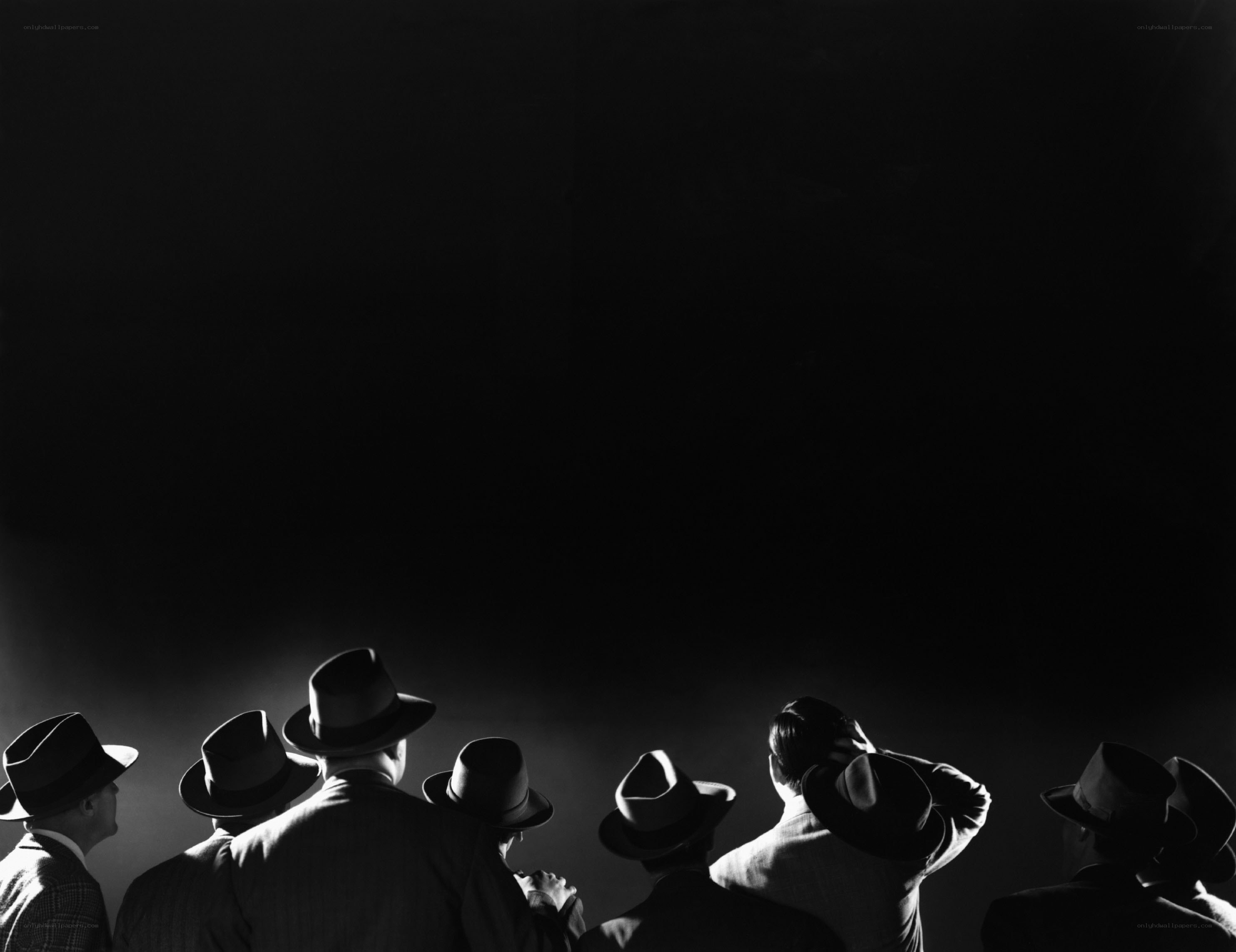 men in hats watching performance