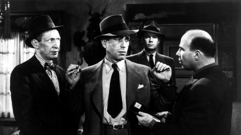 Men in suits and hats in a tense scene