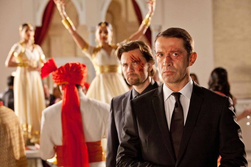 Men in suits at a cultural event