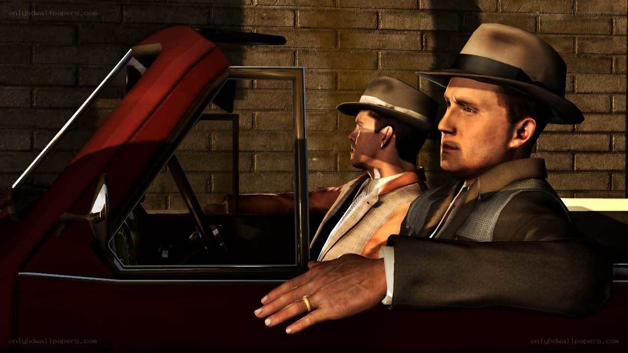 men in suits by red car