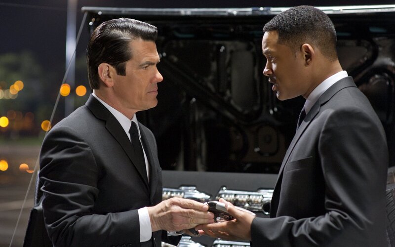 Men in suits exchanging device