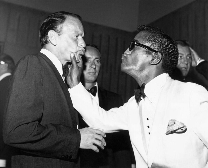 Men in suits interacting at event