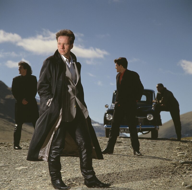 Men in suits on a gravel road