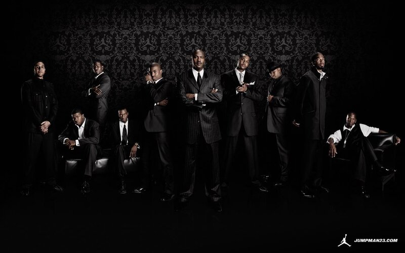 men in suits posing for photo