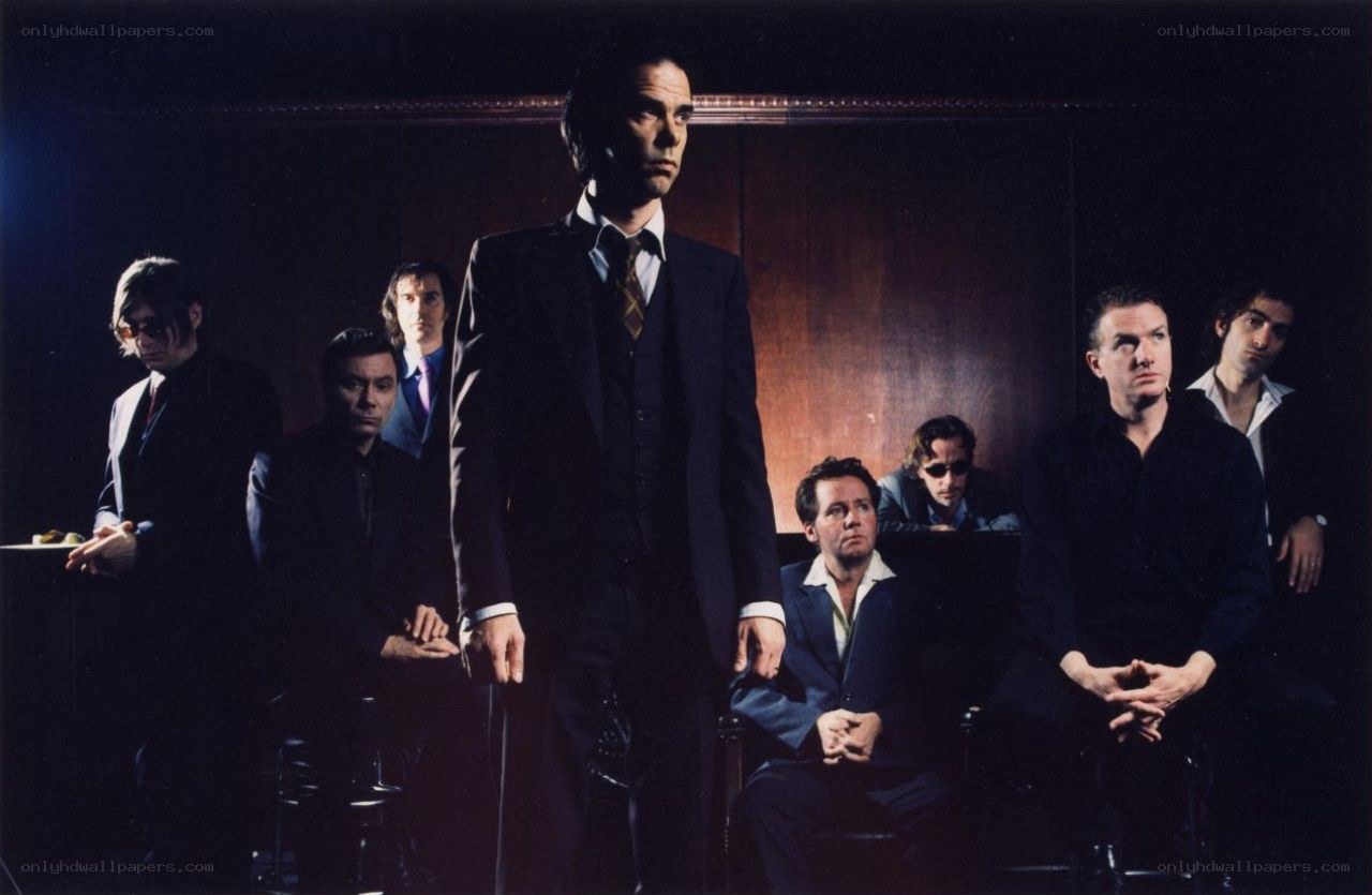men in suits standing and sitting