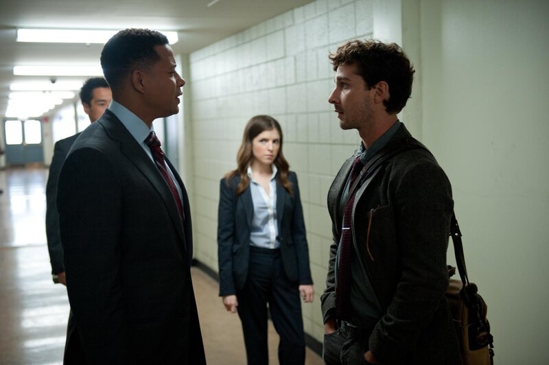 Men in suits talking in hallway