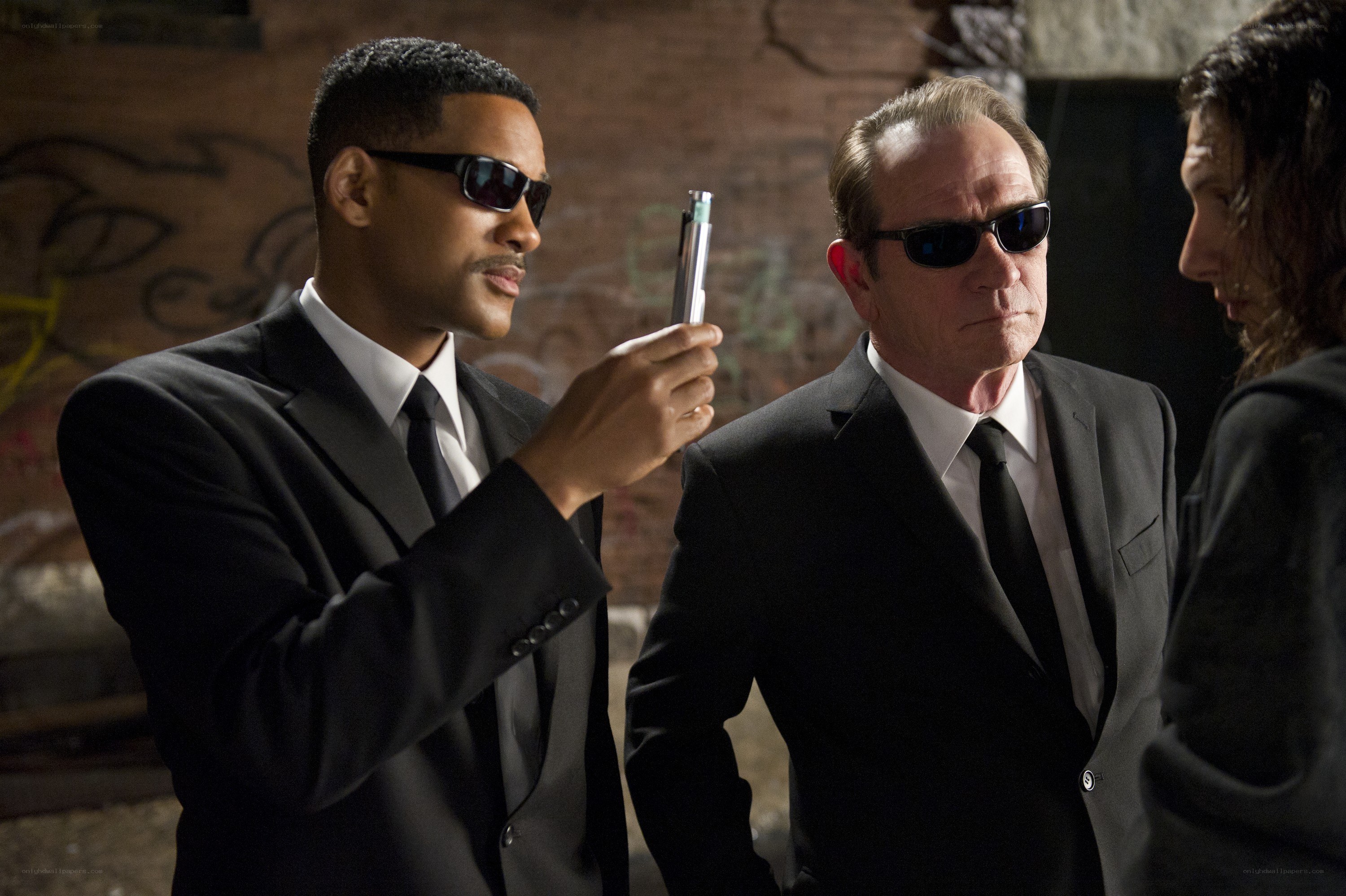 Men in suits with a gun