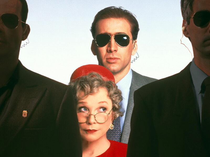 Men in suits with a woman in red