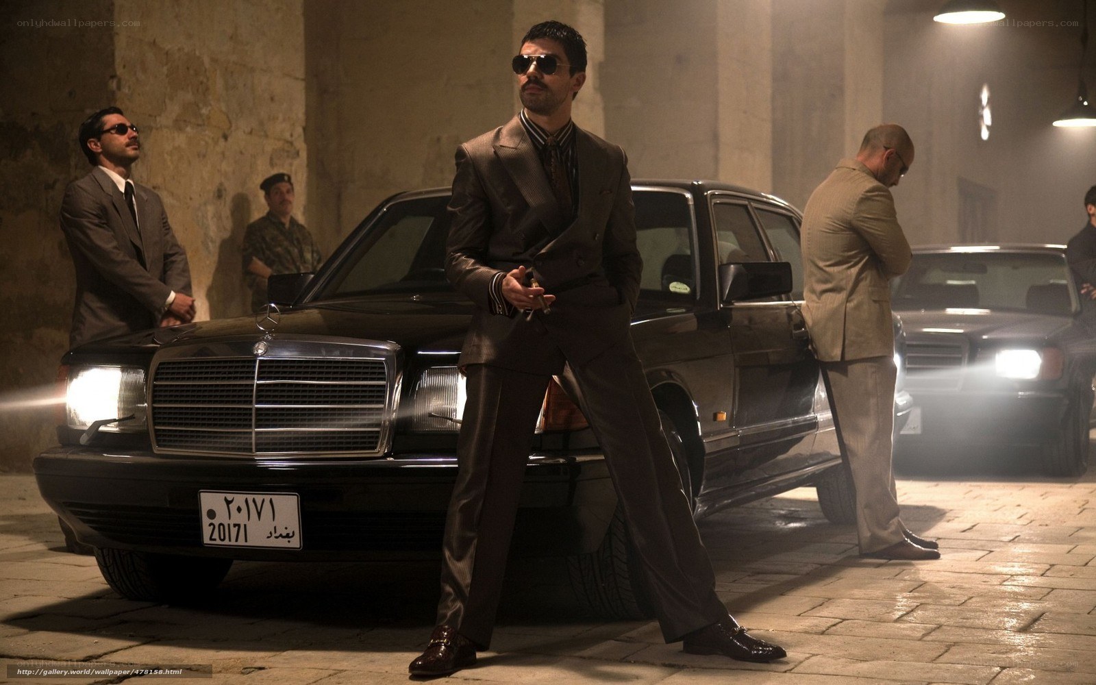 Men in suits with cars at night