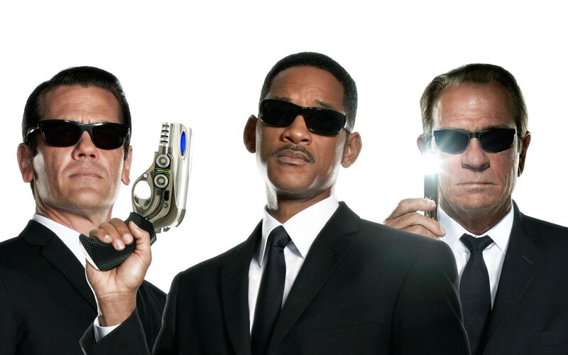 Men in suits with futuristic guns