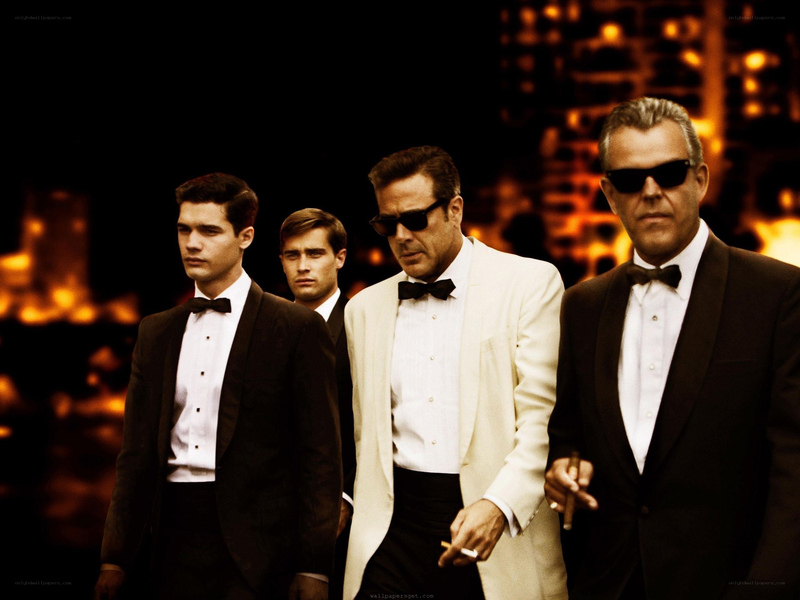 Men in tuxedos walking at night